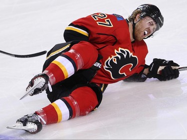 Calgary Flames Dougie Hamilton hits the ice after being hooked by Jason Pominville of the Minnesota Wild during NHL hockey in Calgary, Alta., on Wednesday, February 17, 2016. Al Charest/Postmedia