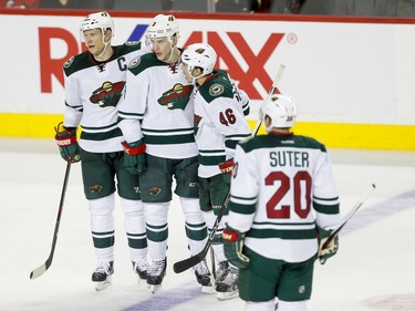 Mikko Koivu, Charlie Coyle, Jared Spurgeon and Ryan Suter of the Minnesota Wild celebrate an empty-net goal on the Calgary Flames in Calgary, Alta., on Wednesday, Feb. 17, 2016. The Wild won 5-3. Lyle Aspinall/Postmedia Network