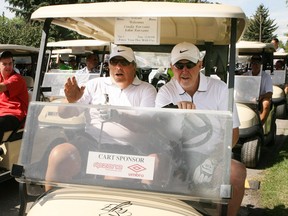 John Forzani, chairman and founder of the Forzani group, left, and Basil Bark are pictured in this image from a 2010 golf tournament. Forzani, his brothers Tom and Joe Forzani, and Bark were all inducted to the Alberta Sports Hall of Fame this week.