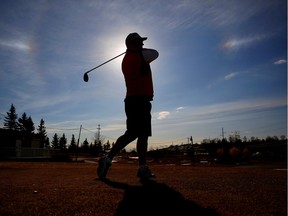 Eric Dennis enjoys the first day of golfing in Calgary on Feb. 16, 2016, at Fox Hollow. Leah Hennel/Postmedia