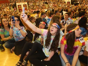 Lauren Smith holds the phone for a selfie as she and her Grade 12 friends at Bishop Grandin High School get into the tie dye spirit Grooving Into the Record Books in the school gym on Friday, Feb. 26, 2016. Pictured from the left are Meagan MacMillan, Cassie Haggerty, Marcelyn Buluran, Smith and Emily Wagner. The school broke the record for the largest number of people gathered together wearing tie dye shirts.