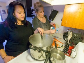 Danielle Stewart (right) and Tammi Dagley, organizers of YYC Helping Homeless, prep food at Dagley's home in Calgary.