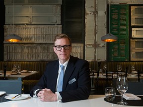 Fraser Abbott sits for a photo inside the Yellow Door Bistro, attached to Hotel Arts, in Calgary on Wednesday, Feb. 10, 2016. Abbott is the director of business development with the Hotel Arts Group, as well as chair of the Alberta Culinary Tourism Alliance. Lyle Aspinall/Postmedia Network