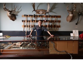 Nathan Gareau, manager of Kent of Inglewood, stands at an antique glass display case that was broken to steal merchandise during an early morning break-in Wednesday, Feb. 10, 2016.