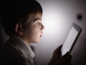 In this file photo illustration, a 10-year-old uses an iPad.