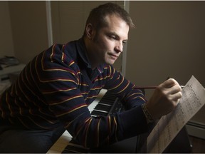 Jamie Serafi, a transplant from the U.K. six months ago, sits for a photo with his piano inside his condo in Calgary, Alta., on Wednesday, Feb. 10, 2016. Serafi is the composer who scored the Oscar-nominated film Ave Maria.