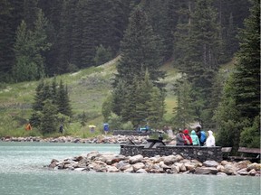 Visitors stop to take a look out at Lake Louise in July 2015.