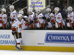 Calgary Flames defenceman Mark Giordano celebrates with his teammates after scoring a goal against the San Jose Sharks during the first period of an NHL hockey game in San Jose, Calif., Thursday, Feb. 11, 2016.