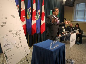 Calgary Mayor Naheed Nenshi speaks as NDP Minister Brian Mason (R) looks on during a press conference for Green TRIP initiative annoucement in Calgary, on Thursday, February 25, 2016. Jim Wells/Postmedia