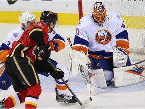 New York islanders Jaroslav Halak makes a save on  Johnny Gaudreau of the Calgary Flames during NHL action in Calgary, Alta., on Thursday, February 25, 2016.