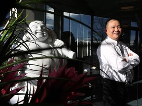Manager of O Phoenix Jimmy Lam poses for a photo at the restaurant in Calgary.