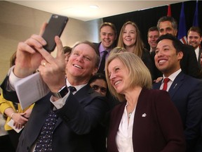 Dave Mowat, who chaired the review into energy royalties, takes a selfie with Premier Rachel Notley and NDP caucus members during the release of the report.