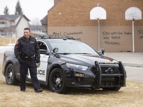 Police respond to hate graffiti at Wilma Hansen School in the Queensland area of Calgary, Alta., on Saturday, Feb. 20, 2016. It wasn't the first time the junior high had been the target of hate graffiti.