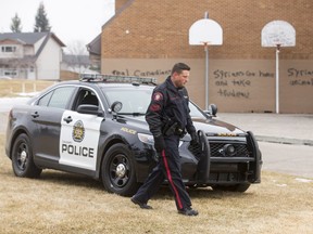 Police investigate hate graffiti at Wilma Hansen School in the Queensland area of Calgary on Saturday, Feb. 20, 2016.