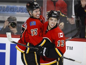Sean Monahan, left, celebrates his goal with Flames teammate Johnny Gaudreau during the third period of Calgary's win over the Caroline Hurricanes on Wednesday at the Saddledome.