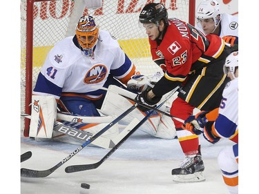 Sean Monahan of the Calgary Flames can't corral a loose puck in front of New York Islanders goalie Jaroslav Halak late in the third period of their 2-1 overtime loss at the Saddledome Thursday night February 25, 2016.