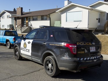 Police park outside of a home in the 1800 block of 38 St NE in Calgary, Alta., on Sunday, Feb. 21, 2016. Early reports said shots had been fired into the home, but there was no early confirmation for media. Lyle Aspinall/Postmedia Network