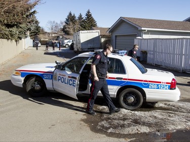Police at a home in the 1800 block of 38 St NE in Calgary, Alta., on Sunday, Feb. 21, 2016. Early reports said shots had been fired into the home, but there was no early confirmation for media. Lyle Aspinall/Postmedia Network