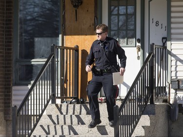 Police work inside a home in the 1800 block of 38 St NE in Calgary, Alta., on Sunday, Feb. 21, 2016. Early reports said shots had been fired into the home, but there was no early confirmation for media. Lyle Aspinall/Postmedia Network