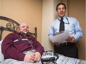 Ryan Atkinson, left, and Dr. Charles Samuels show off a set of monitoring tools at the Calgary Centre for Sleep and Human Performance in Calgary.