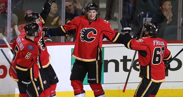 Calgary Flames Joe Colborne celebrates with teammates after scoring against the Vancouver Canucks during NHL hockey in Calgary, Alta. on Friday February 19, 2016. Al Charest/Postmedia