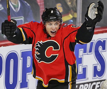 Flames Mark Giordano (L) celebrates his second period goal with teammate Sean Monahan during NHL action between the Carolina Hurricanes and the Calgary Flames in Calgary, Alta. on Wednesday February 3, 2016 at the Scotiabank Saddledome. Jim Wells/Postmedia