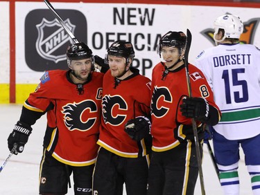 Calgary Flames Johnny Gaudreau celebrates after a goal by Mark Giordano against Eddie Lack and Carolina Hurricanes during NHL hockey in Calgary, Alta., on Wednesday, February 3, 2016. Al Charest/Postmedia