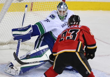 Vancouver Canucks Jacob Markstrom makes a save on a shot by Sean Monahan of the Calgary Flames during NHL hockey in Calgary, Alta., on Friday, February 19, 2016. Al Charest/Postmedia