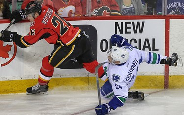 Calgary Flames Tyler Wotherspoon collides with Adam Cracknell of the Vancouver Canucks during NHL hockey in Calgary, Alta., on Friday, February 19, 2016. Al Charest/Postmedia