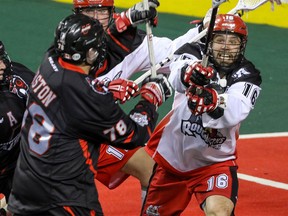 Calgary Roughnecks Mike Carnegie tries to stop a shot by Vancouver Stealth Jordan Durston in NLL action at the Scotiabank Saddledome in Calgary, Alta. on Saturday January 30, 2016. Mike Drew/Postmedia