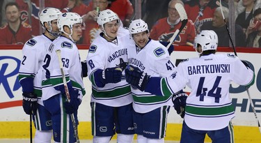 Vancouver Canucks Jake Virtanen#18 celebrates with teammates after scoring against the Calgary Flames during NHL hockey in Calgary, Alta. on Friday February 19, 2016. Al Charest/Postmedia