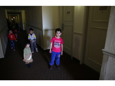 Syrian refugee children play in the halls at a Calgary hotel, their first temporary home in Canada, on Tuesday February 23, 2016.