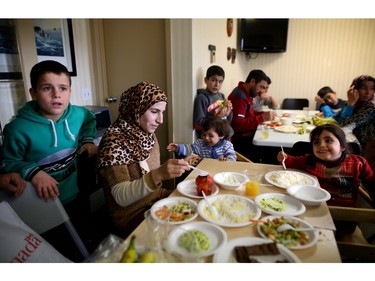 Syrian Refugee families gather in a hotel to eat ethnic food during their first weeks in Calgary.