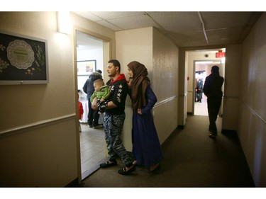 Syrian refugee families make their way to the hotel lunchroom.