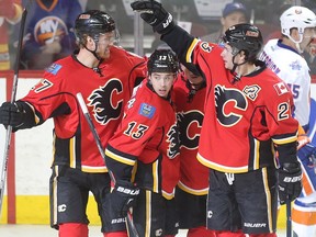 The Calgary Flames, from left, Douglie Hamilton, Johnny Gaudreau, Jiri Hudler, behind, and Sean Monahan celebrate Hudler's goal, the only score of the first period against the New York Islanders at the Saddledome Thursday night, February 25, 2016. (Ted Rhodes/Postmedia)