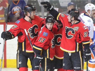 Calgary Flames players, from left, Douglie Hamilton, Johnny Gaudreau, Jiri Hudler, behind, and Sean Monahan celebrate Hudler's goal, the only score of the first period against the New York Islanders at the Saddledome Thursday night February 25, 2016.