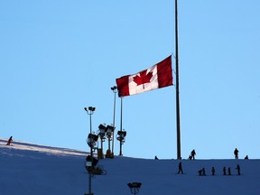 The flag at the top of Canada Olympic Park flies at half mast following the deaths of two teens on the bobsled track.