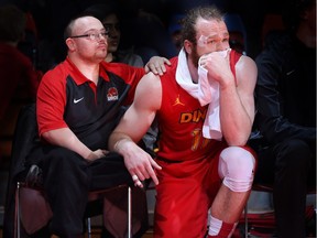 University of Calgary Dinos men's basketball senior Matt Letkeman, right, is being consoled by long-time water boy Bill Hurley during Letkeman's final regular-season home game at the Jack Simpson Gym on Feb. 11, 2016.