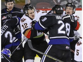 Victoria Royals Marsel Ibragimov tangles with Calgary Hitmen Mark Kastelic in WHL action at the Scotiabank Saddledome in Calgary, Alberta, on Friday, February 26, 2016. The Hitmen lost to the Royals 6-2. Mike Drew/Postmedia