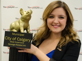 Paige T. MacPherson, Alberta Director of the Canadian Taxpayers Federation, holds a Teddy Waste Award, won by the City of Calgary, for spending an extra $246,000 on art for the Forest Lawn Lift Station. Supplied photo.