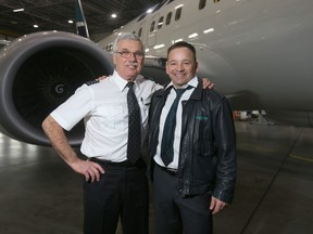 WestJet's George Hawey (L) and Gerry Erlam, his co-pilot for the flight in a hangar in Calgary.
