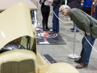 A man has a peek at a car during the World of Wheels show at the BMO Centre in Calgary, Alta., on Sunday, Feb. 21, 2016. The popular auto-enthusiast show was in its 50th year. Lyle Aspinall/Postmedia Network