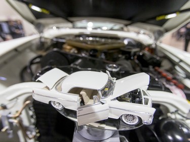 A scale-model 1956 Chrysler 300 spins under the hood of its full-size big brother during the World of Wheels show at the BMO Centre in Calgary, Alta., on Sunday, Feb. 21, 2016. The popular auto-enthusiast show was in its 50th year. Lyle Aspinall/Postmedia Network