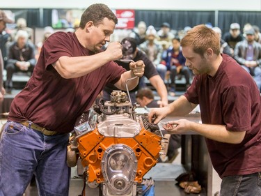 Stacy Schultz (R) and Chuck Jones, also known as the 'Broke Hillbillies' scramble through the assembly of a 305 Chevy small-block engine in the Zeebs Battle of the Techs during the World of Wheels show at the BMO Centre in Calgary, Alta., on Saturday, Feb. 20, 2016. Battle of Techs features 10 teams competing during the popular auto-enthusiast show, with each team trying to be the quickest at assembling the engine out of 192 parts and using nine hand toold. Lyle Aspinall/Postmedia Network