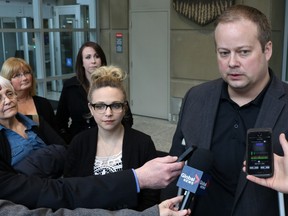 Wyatt Lewis' brother James Carmichael, right and Lewis' wife Leigh, left, comment outside the Calgary Courts Centre after James Rajbhandari was convicted in the second degree murder of Lewis who was stabbed on Sept. 1, 2012.