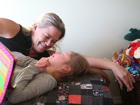 Photojournalist Christina Ryan reads to her daughter Emily Pitchers,16, who has numerous medical conditions, including Down Syndrome and epilepsy.