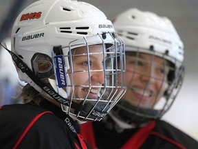 University of Calgary Dinos women's hockey player Iya Gavrilova, left.