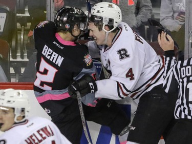 Calgary Hitmen Jake Bean and Red Deer Rebels Haydn Fleury knock heads just before the final whistle in WHL action at the Scotiabank Saddledome in Calgary, Alberta, on Sunday, March 6. The Hitmen lost to the Rebels 4-3. Mike Drew/Postmedia