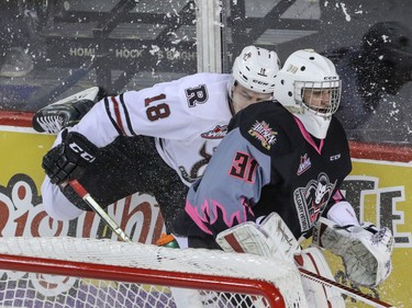 Red Deer Rebels Braden Purtill puts on the brakes to avoid interfering with Calgary Hitmen goalie Cody Porter behind the net in WHL action at the Scotiabank Saddledome in Calgary, Alberta, on Sunday, March 6, Mike Drew/Postmedia