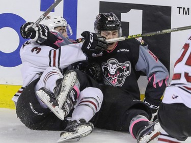 Calgary Hitmen Matteo Gennaro gets hauled into the boards by Red Deer Rebels Colton Bobyk in WHL action at the Scotiabank Saddledome in Calgary, Alberta, on Sunday, March 6. The Hitmen lost to the Rebels 4-3. Mike Drew/Postmedia